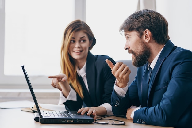 Managers sitting in front of a laptop teamwork professionals