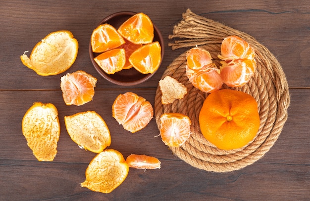 mandarin on rope top view on wooden table