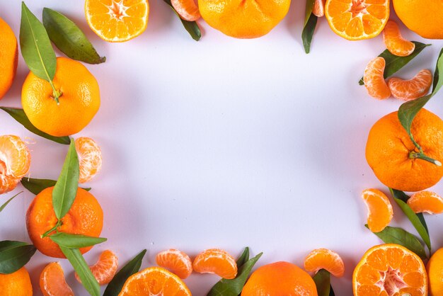 Mandarins frame top view with copy space on white surface