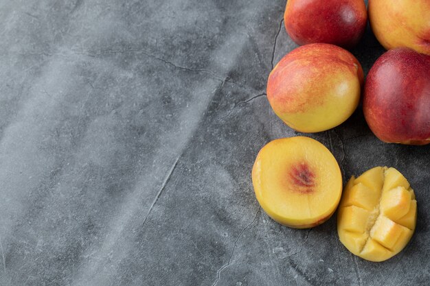 Mango and peaches on grey