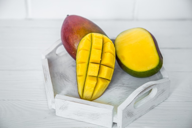 Mango on white wooden background