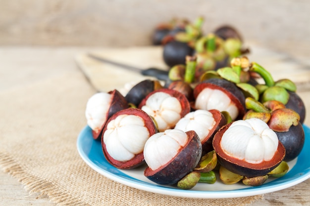 Free photo mangosteen on wood table.