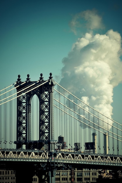 Manhattan Bridge with chimney smoke in New York City