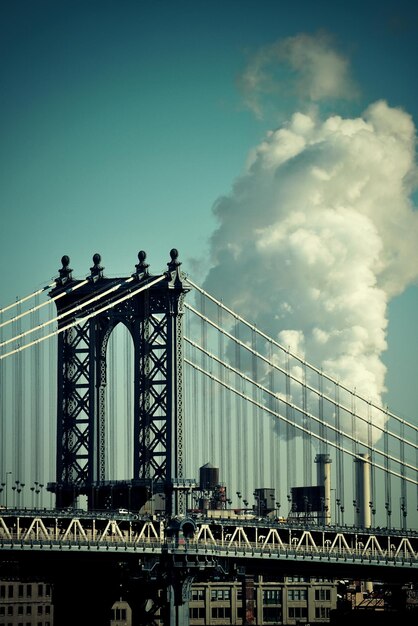 Manhattan Bridge with chimney smoke in New York City