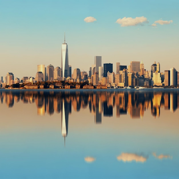 Manhattan downtown skyline with urban skyscrapers over river with reflections.