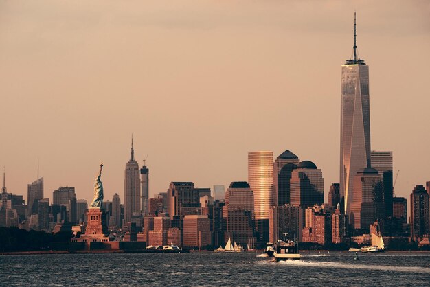 Manhattan downtown skyline with urban skyscrapers over river.