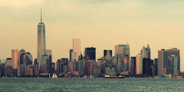 Manhattan downtown skyline with urban skyscrapers over river.