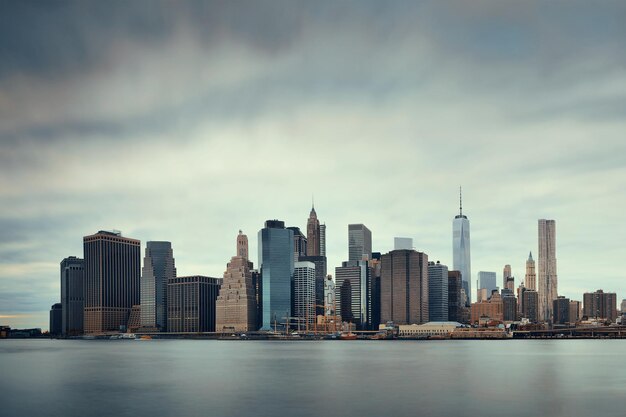 Manhattan financial district with skyscrapers over East River.