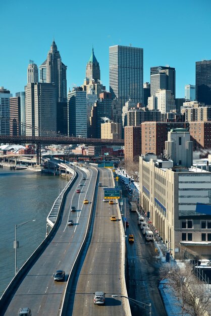 Manhattan financial district with skyscrapers and highway over East River.