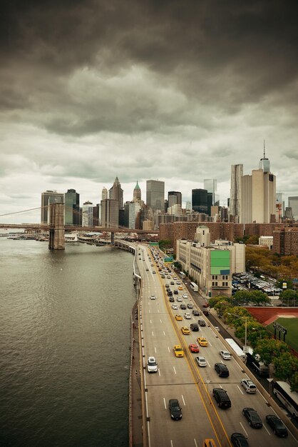 Manhattan financial district with skyscrapers and highway over East River.