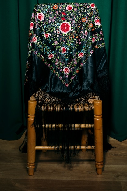 Free photo mania shawl on a wooden chair