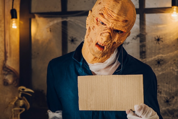 maniac man in costume with tablet