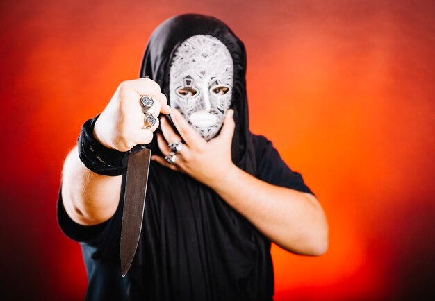 Maniac in mask and with knife