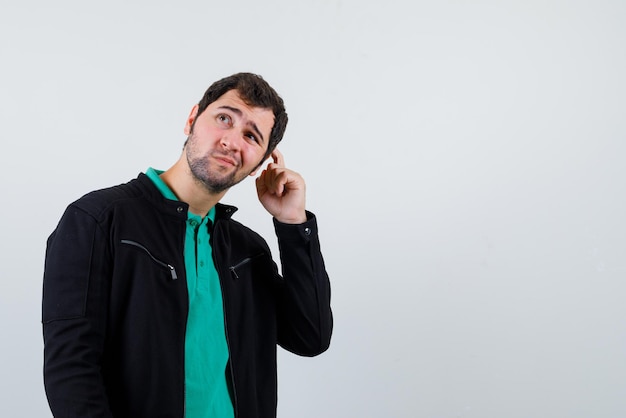 Free photo the manis thinking by holding his forefingwer on temple  on white background