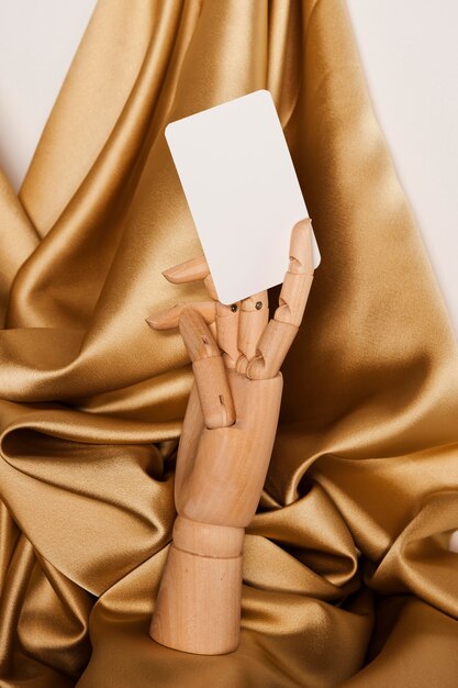 Mannequin hand holding white paper