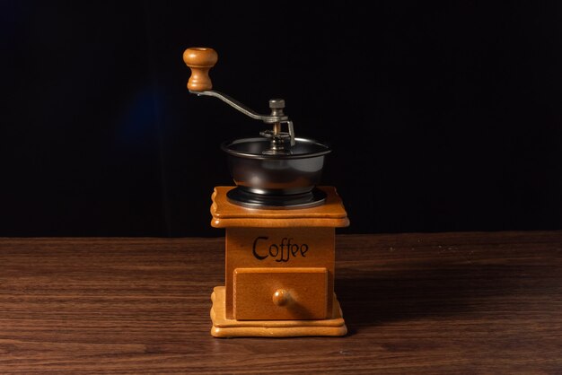 Manual coffee grinder on black background