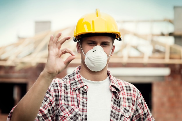 Manual worker with hard hat and protective mask