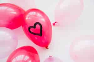 Free photo many balloons with painted heart