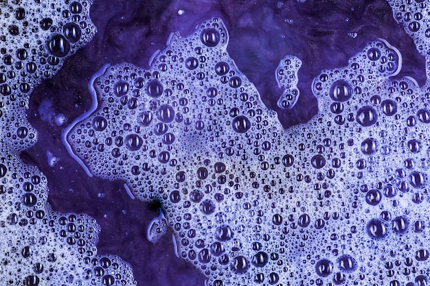 Many blobs on violet liquid