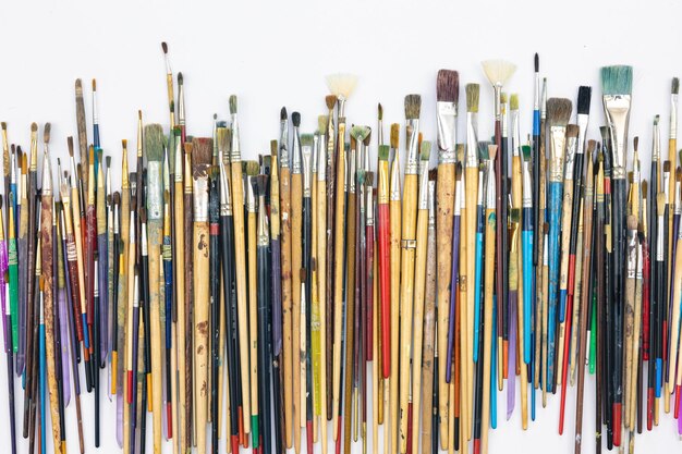 Many brushes for painting on a white background top view