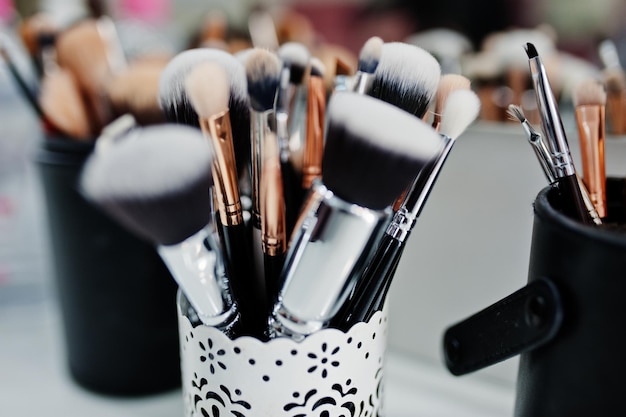 Many brushes on a table in the salon Workplace makeup artist Set of brushes for makeup