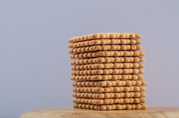 Many of delicious fresh crackers on a wooden board.