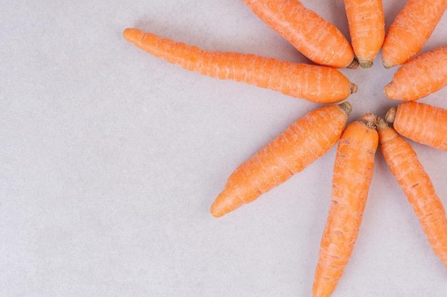 Many of fresh carrots on white table