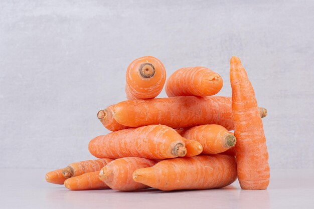 Many of fresh carrots on white table