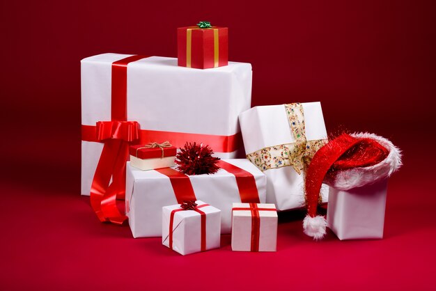 Many gifts with beautiful ribbons on red background