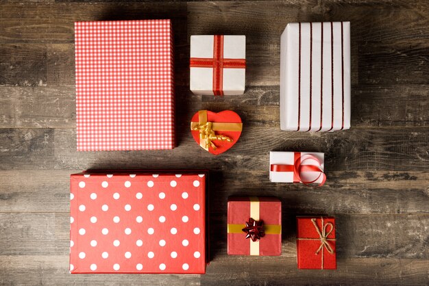 Many gifts with ribbons on wooden board