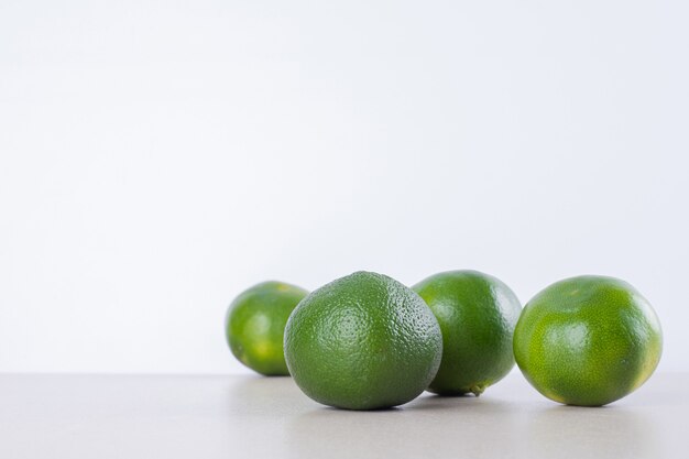 Many of green tangerine on marble.