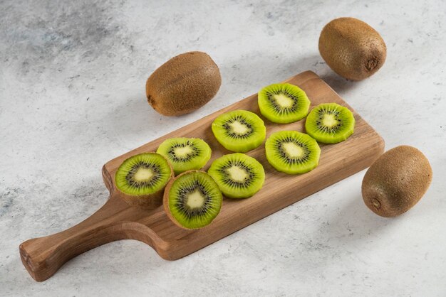 Many of kiwi fruits on wooden board. 