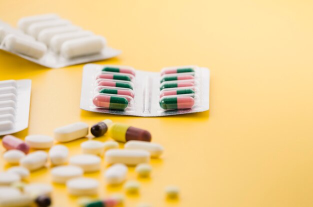 Free photo many pill blister pack on yellow background