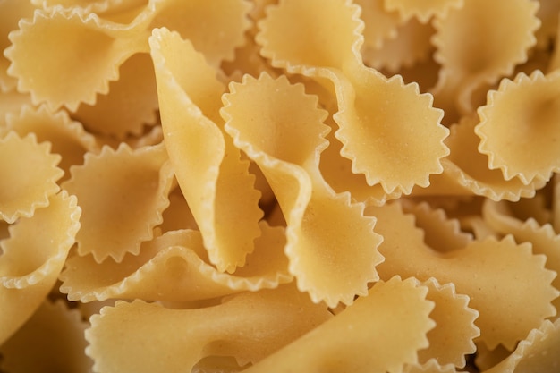 Many raw farfalle tonde as a table. 