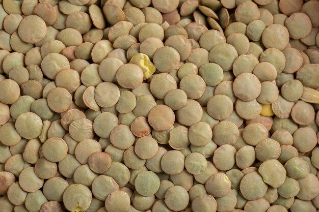 Many of unprepared dried brown lentils.