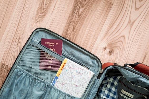 Free photo map and passport in suitcase