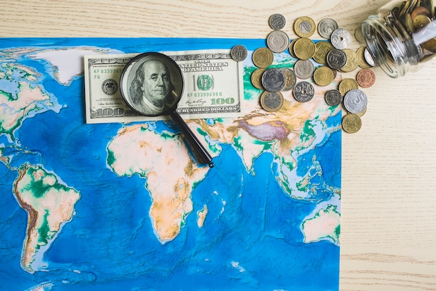 Free photo map of the world with money and magnifying glass