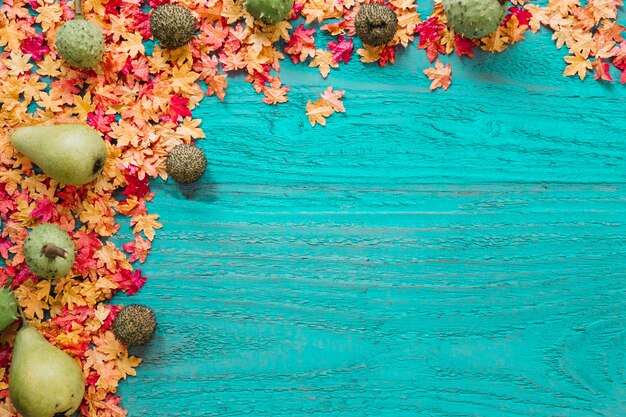 Maple leaves and organic products on wooden background
