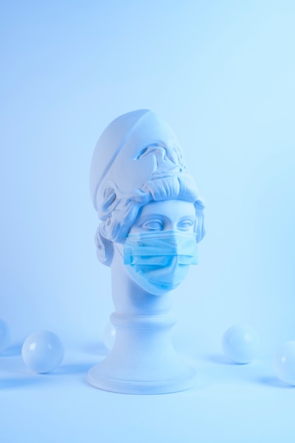 Free photo marble sculpture of historical figure with medical mask and balls