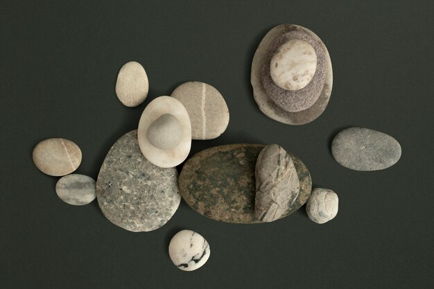 Marble zen stones stacked on green background in health and wellbeing concept