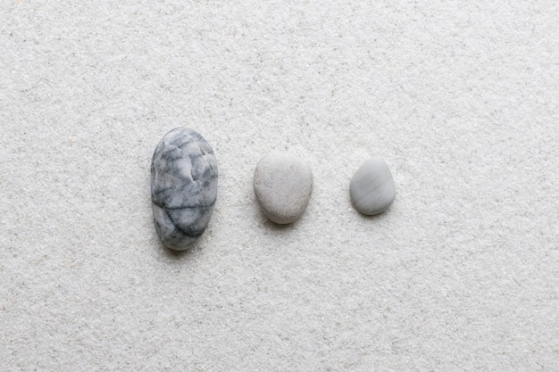 Marble zen stones stacked on white background in stability concept