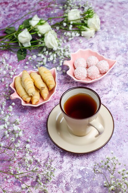 March 8 Women's Day card with white flowers,sweets and a cup of tea .