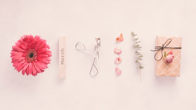 March inscription with flowers and gift box on table