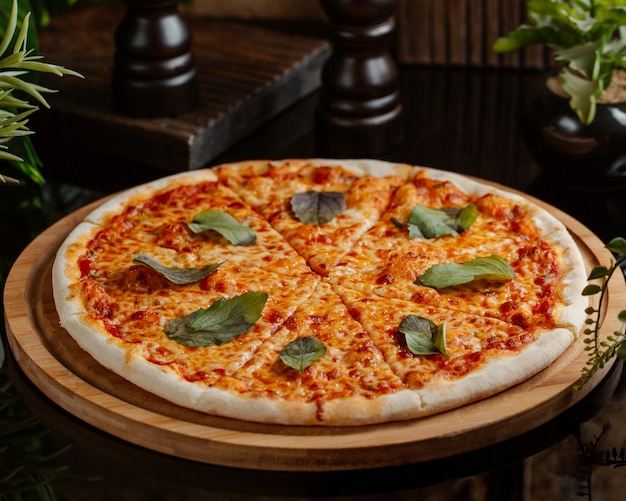Margharita pizza with full tomato sauce andgreen basilica leaves per slice