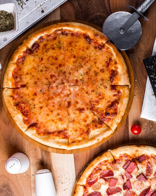 Margherita pizza with salt and pepper shakers on the table