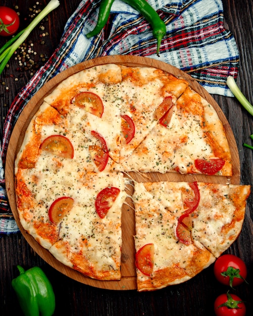 margherita pizza with slices of lemon on a wooden tray