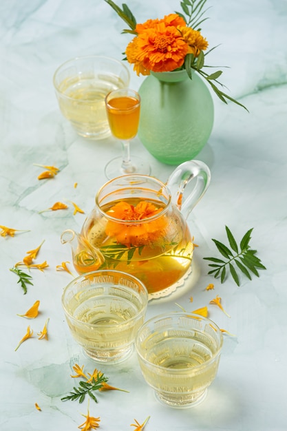 Free photo marigold, lemon, honey herbal tea treatment concept.