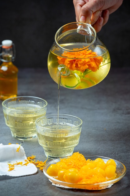 Free photo marigold, lemon, honey herbal tea treatment concept.