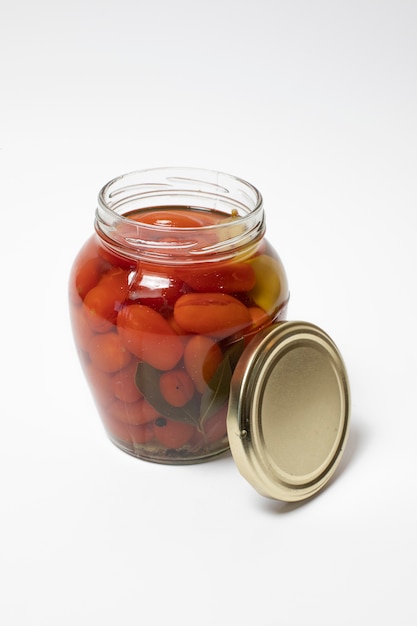 Marinated cherry tomatoes in a glass jar