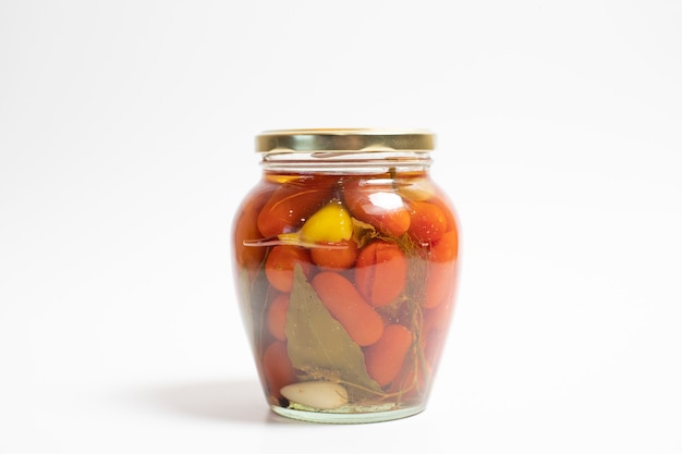 Free photo marinated cherry tomatoes in a glass jar